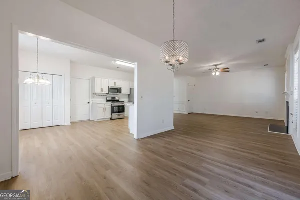 a view of a kitchen with a dishwasher cabinets and wooden floor