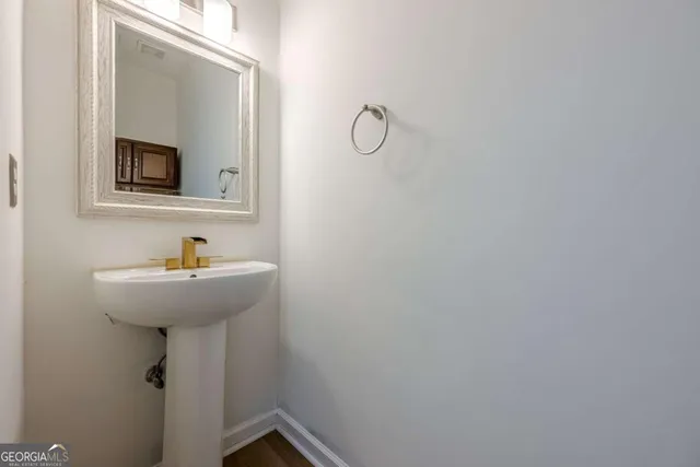 a bathroom with a sink and mirror