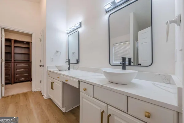 a bathroom with a double vanity sink and a mirror