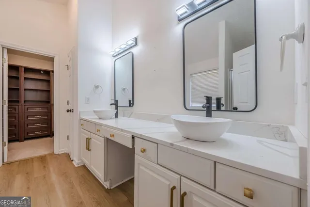 a bathroom with a double vanity sink and a mirror