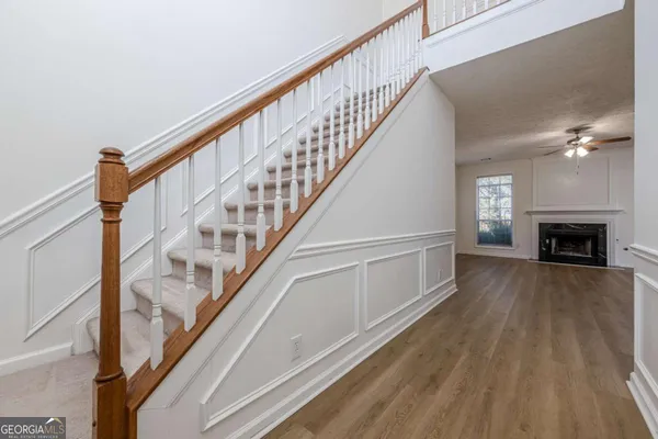 a view of entryway and hall with wooden floor