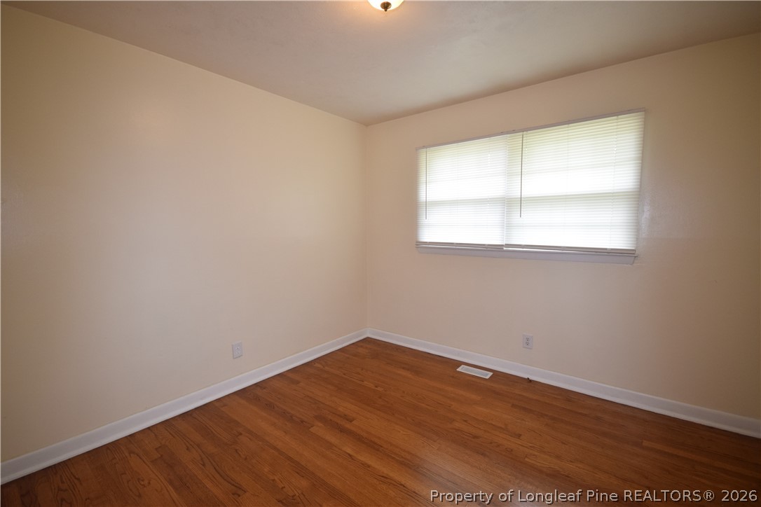 108 South 6th Street Spring Lake, NC 28390 - Photo 3 of 20 an empty room with wooden floor and windows