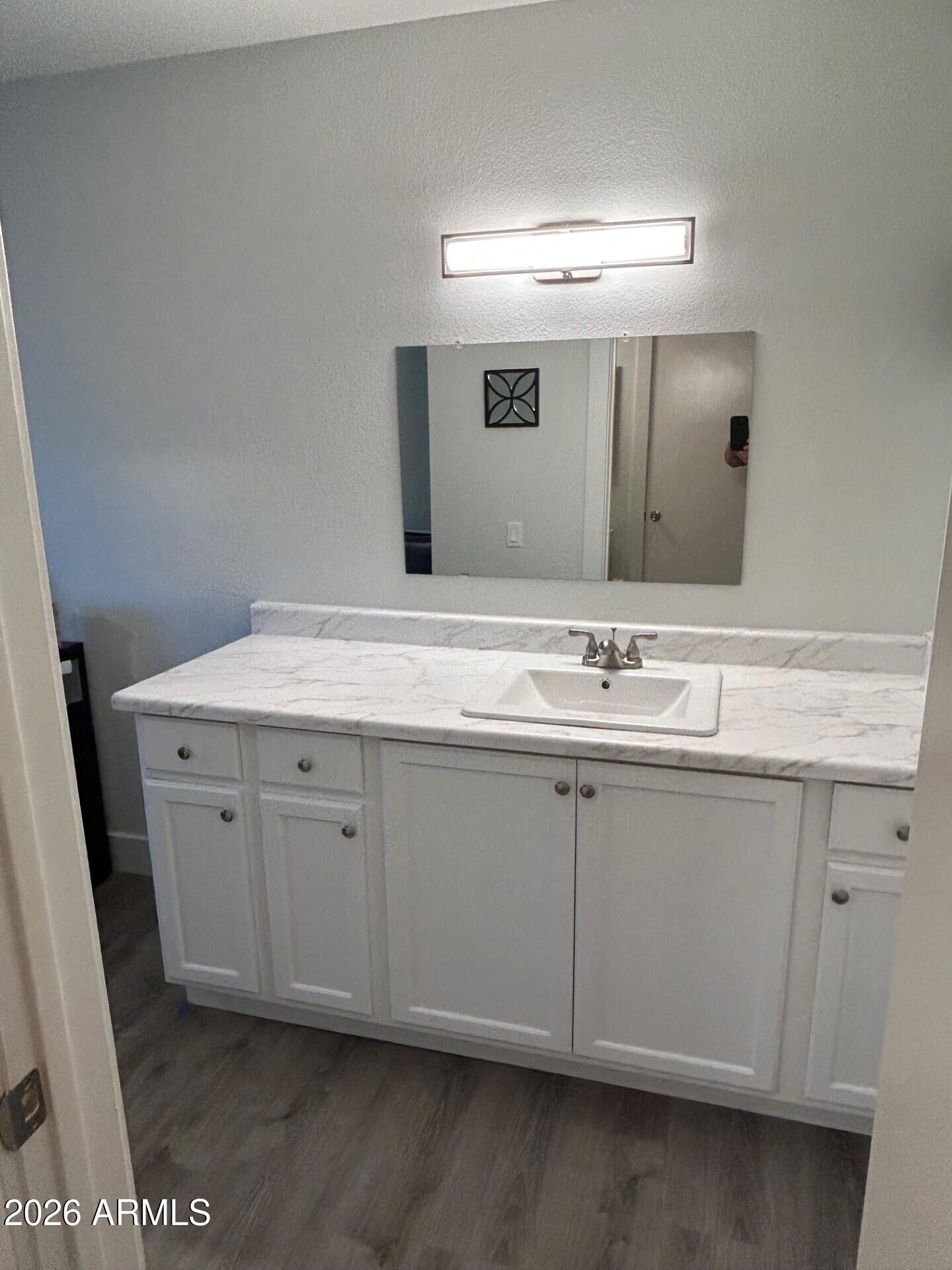 14300 West Bell Road, Unit 423 Surprise, AZ 85374 - Photo 21 of 44 a bathroom with a sink and a mirror