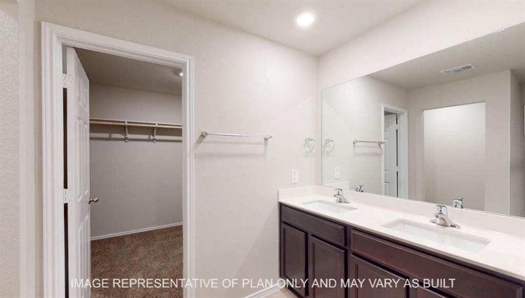 10416 Altair Drive Waco, TX 76708 - Photo 10 of 18 Dual vanity with integrated sinks and chrome fixtures, dark wood-finish cabinetry, and a full-width mirror