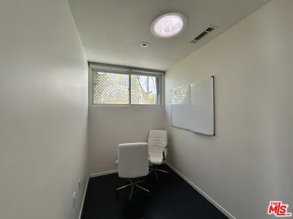 a view of empty room with wooden floor and windows