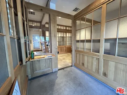 a view of a kitchen with refrigerator and dining table