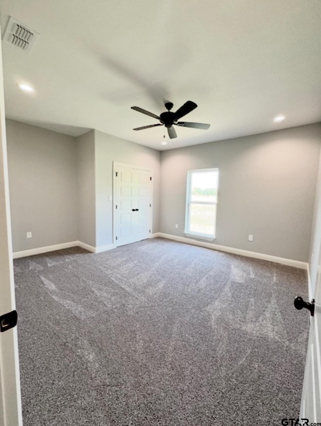 349 Brooks Jefferson, TX 75657 - Photo 22 of 23 an empty room with a ceiling fan and window