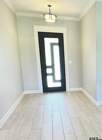 an empty room with wooden floor cabinet and door