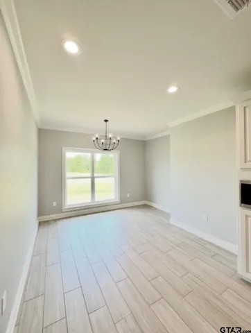 a view of a room with wooden floor and white doors