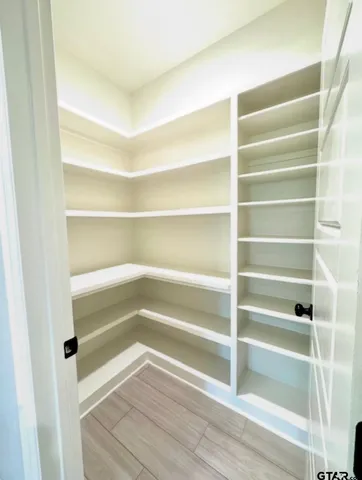 a kitchen with white cabinets and a stove