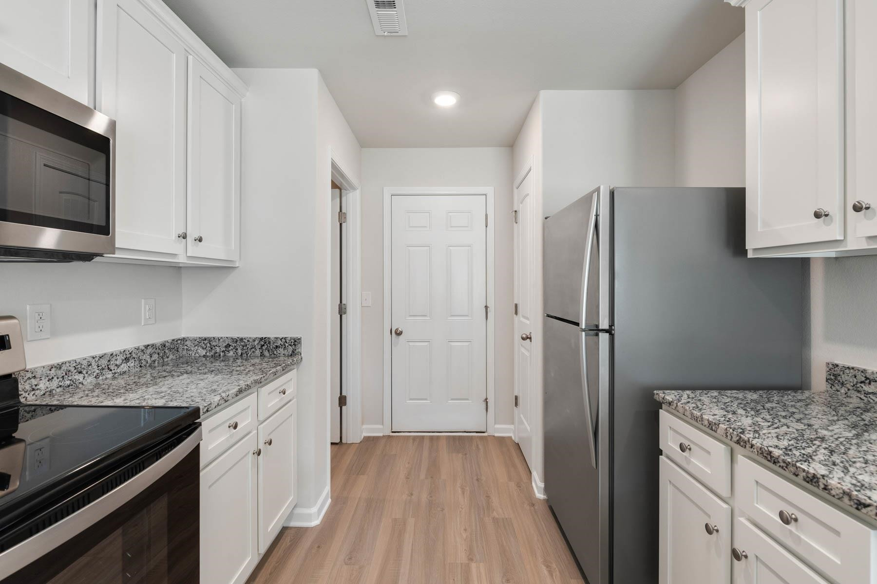 139 Crow Field Street Roxboro, NC 27574 - Photo 9 of 17 a kitchen with stainless steel appliances granite countertop a refrigerator and a stove top oven