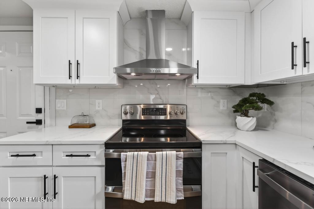 43739 Ratliff Road Callahan, FL 32011 - Photo 25 of 55 a kitchen with a stove and cabinets
