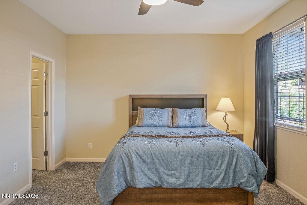 1864 Wind Ranch Road, Unit B Reno, NV 89521 - Photo 17 of 42 a bedroom with a bed and window