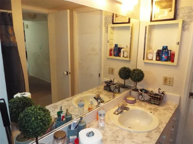 a bathroom with a sink double vanity and a mirror