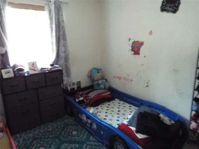 a bedroom with a bed and a dresser