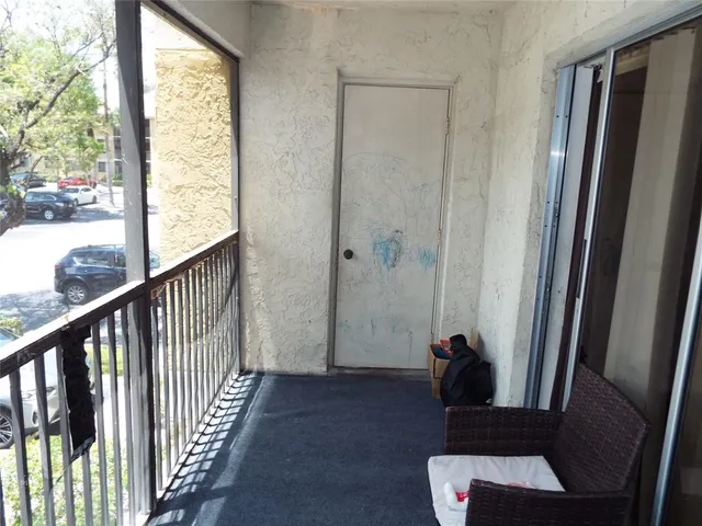 a view of a hallway with wooden floor and stairs