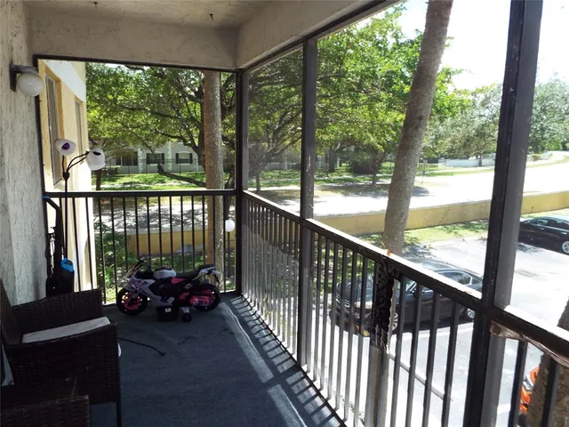 a view of a ocean view from a balcony with chairs