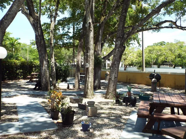 a front view of a house with a tree