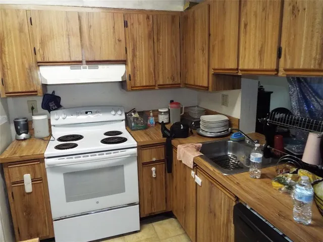 a kitchen with a stove and a white cabinets
