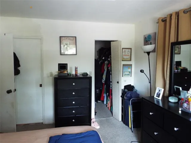 a living room with furniture and a dresser