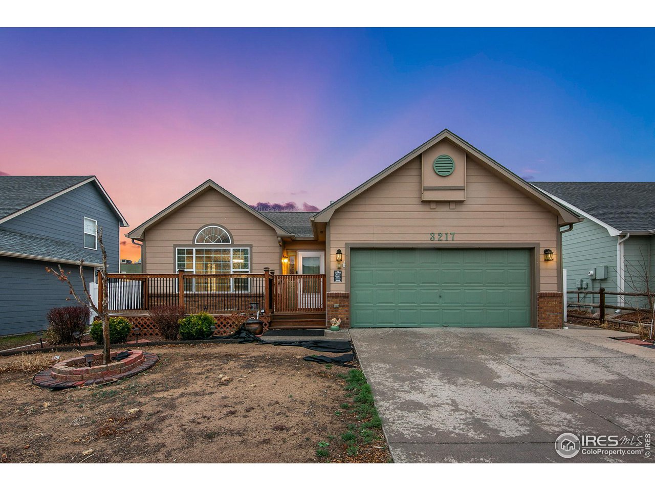 a view of a house with a yard and potted plants