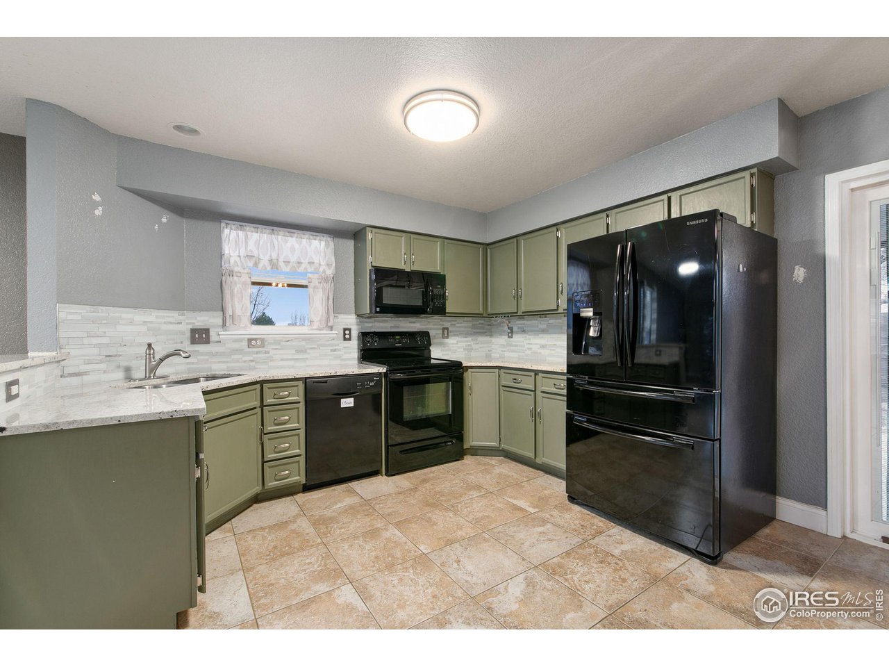 3217 Baldwin Avenue Evans, CO 80620 - Photo 11 of 28 a kitchen with a sink stainless steel appliances and cabinets