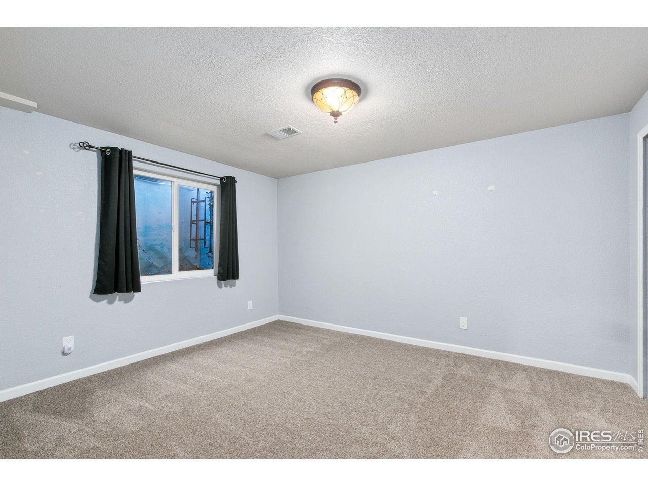 3217 Baldwin Avenue Evans, CO 80620 - Photo 20 of 28 a view of an empty room with a window