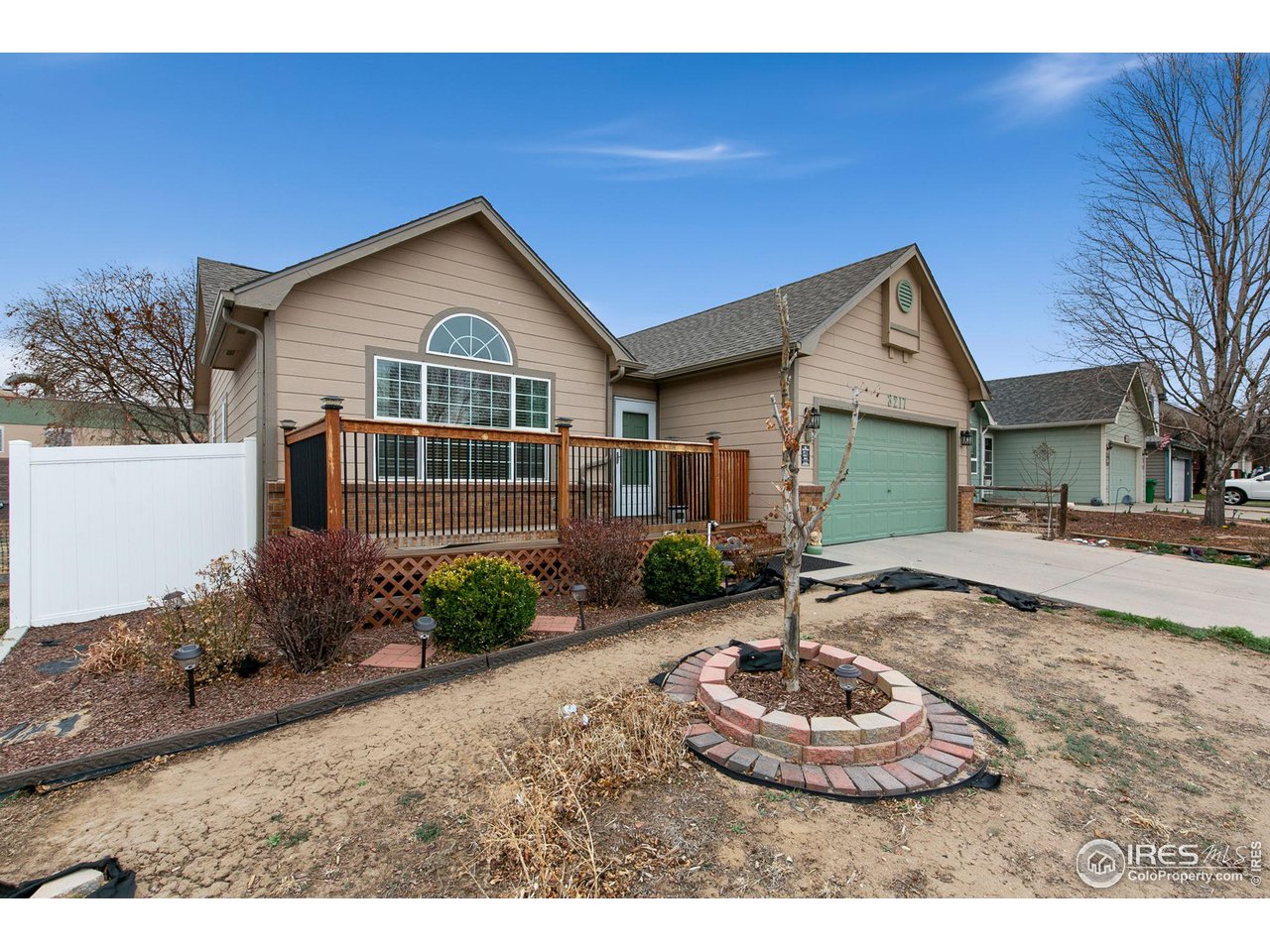 3217 Baldwin Avenue Evans, CO 80620 - Photo 6 of 28 a front view of a house with a yard and garage