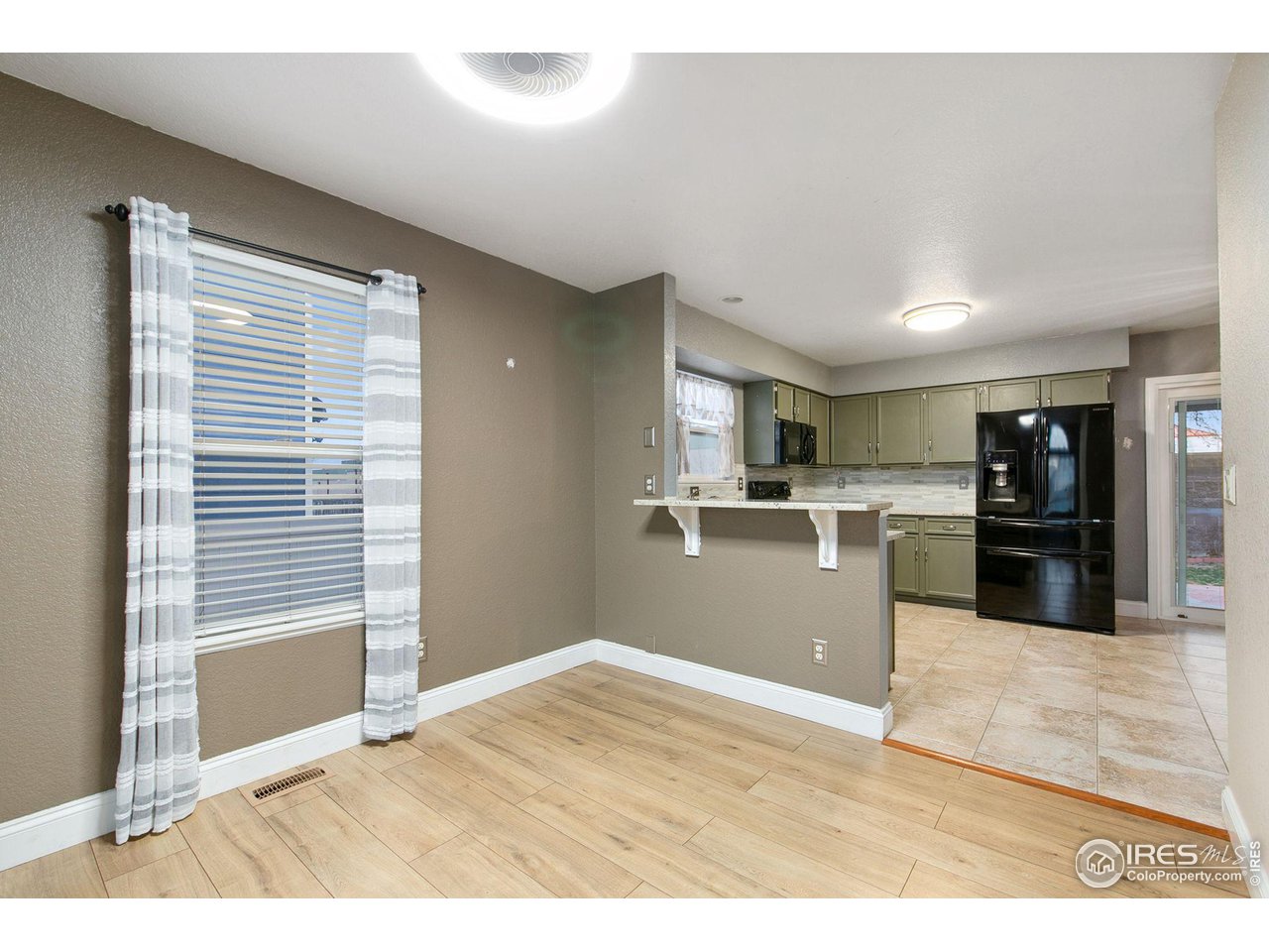 3217 Baldwin Avenue Evans, CO 80620 - Photo 9 of 28 a view of kitchen with wooden floor