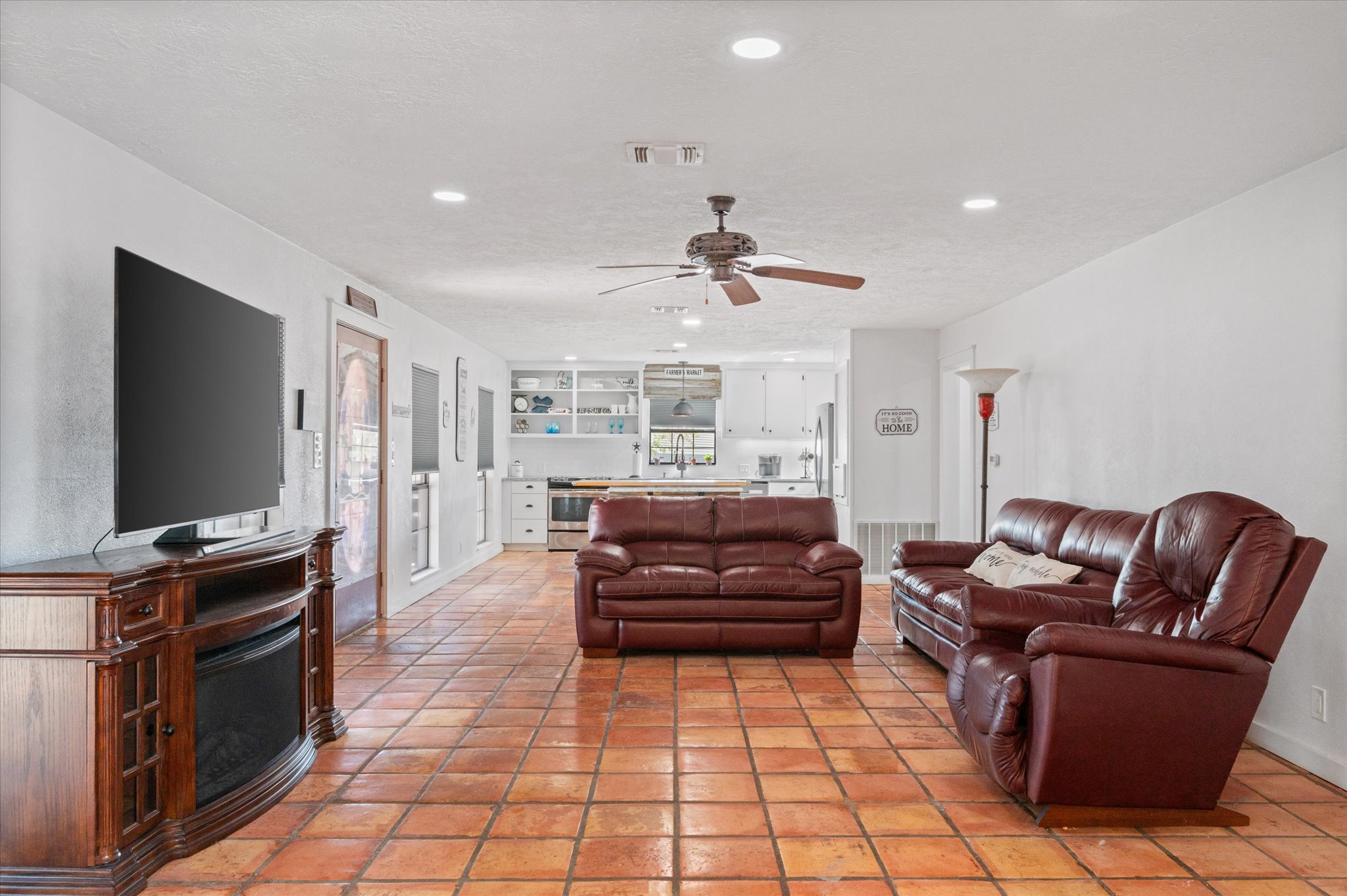 215 Go Away Road Blanco, TX 78606 - Photo 7 of 30 Spacious living area with Saltillo tile floors, recessed lighting, and open flow to the kitchen — perfect for entertaining.