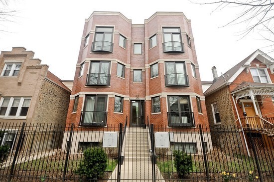 2038 West Iowa Street, Unit 2W Chicago, IL 60622 - Photo 1 of 11 a front view of a multi story residential apartment building
