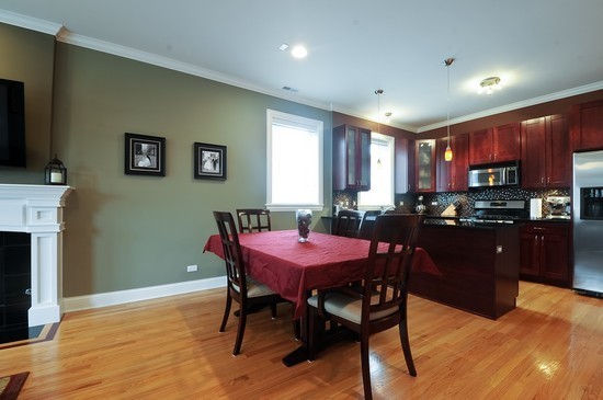 2038 West Iowa Street, Unit 2W Chicago, IL 60622 - Photo 4 of 11 a kitchen with a table chairs refrigerator and microwave