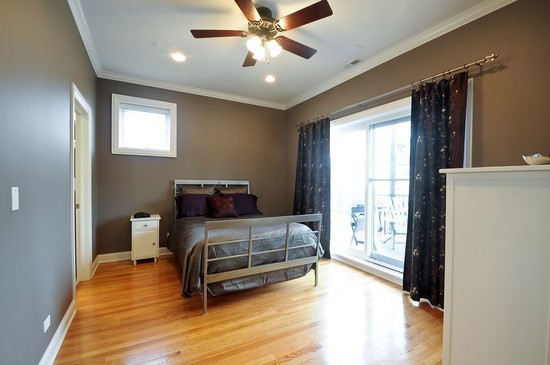 2038 West Iowa Street, Unit 2W Chicago, IL 60622 - Photo 7 of 11 a bedroom with a bed and a window