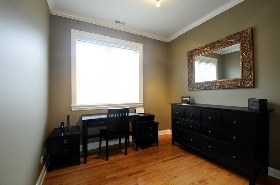 2038 West Iowa Street, Unit 2W Chicago, IL 60622 - Photo 9 of 11 a room with a chair and a dresser