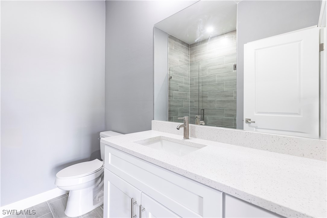 2422 Mae Avenue South Lehigh Acres, FL 33973 - Photo 16 of 28 a bathroom with a sink a toilet and shower