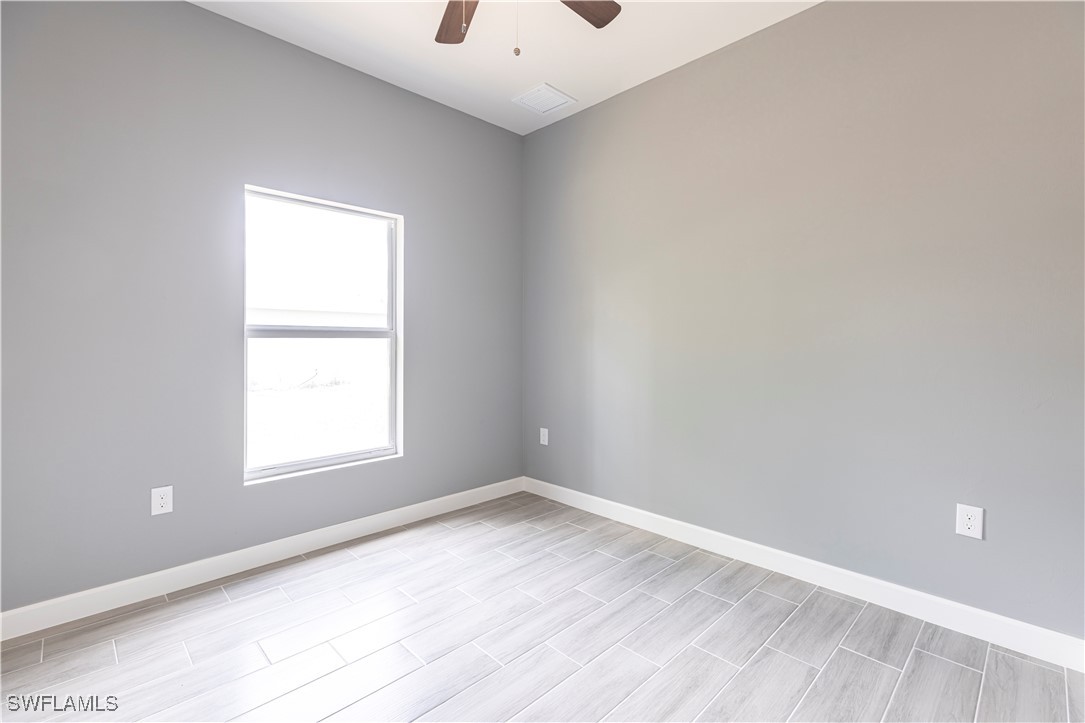 2422 Mae Avenue South Lehigh Acres, FL 33973 - Photo 21 of 28 an empty room with a window
