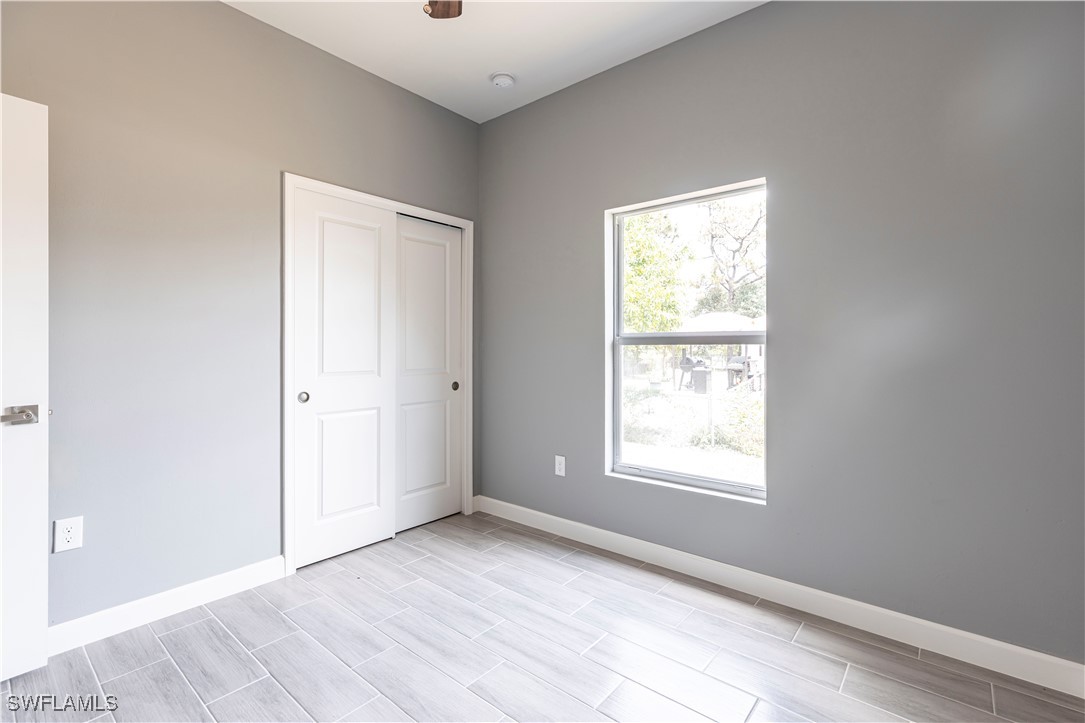 2422 Mae Avenue South Lehigh Acres, FL 33973 - Photo 22 of 28 an empty room with windows