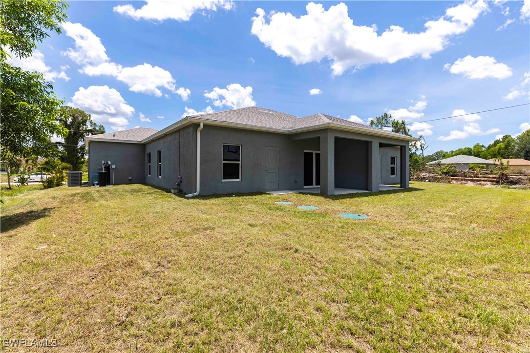 2422 Mae Avenue South Lehigh Acres, FL 33973 - Photo 23 of 28 a view of a house with a yard