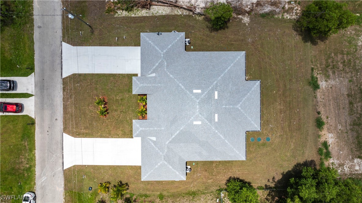 2422 Mae Avenue South Lehigh Acres, FL 33973 - Photo 24 of 28 an aerial view of a house with a yard