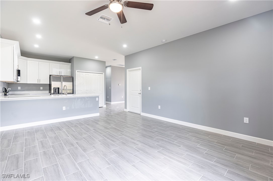 2422 Mae Avenue South Lehigh Acres, FL 33973 - Photo 5 of 28 a view of a kitchen with marble kitchen and stainless steel appliances