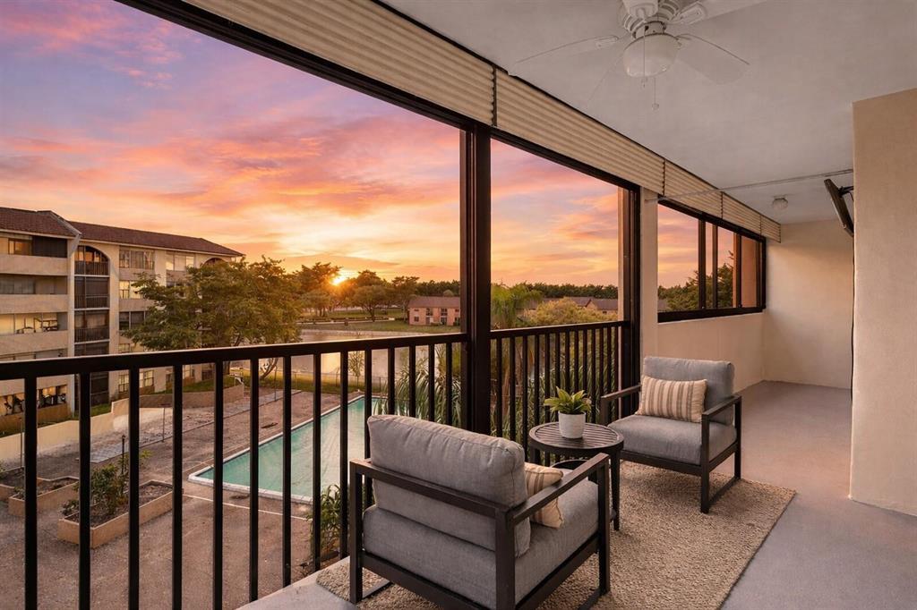3955 North Nob Hill Road, Unit 404 Sunrise, FL 33351 - Photo 11 of 14 a balcony with furniture