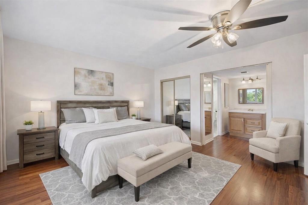 3955 North Nob Hill Road, Unit 404 Sunrise, FL 33351 - Photo 2 of 14 a spacious bedroom with a bed a couch and a chandelier