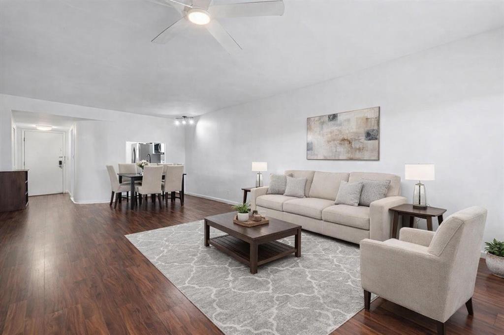 3955 North Nob Hill Road, Unit 404 Sunrise, FL 33351 - Photo 6 of 14 a living room with furniture a wooden floor and a chandelier