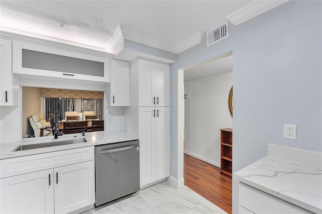 3955 North Nob Hill Road, Unit 404 Sunrise, FL 33351 - Photo 10 of 14 a kitchen with white cabinets and appliances