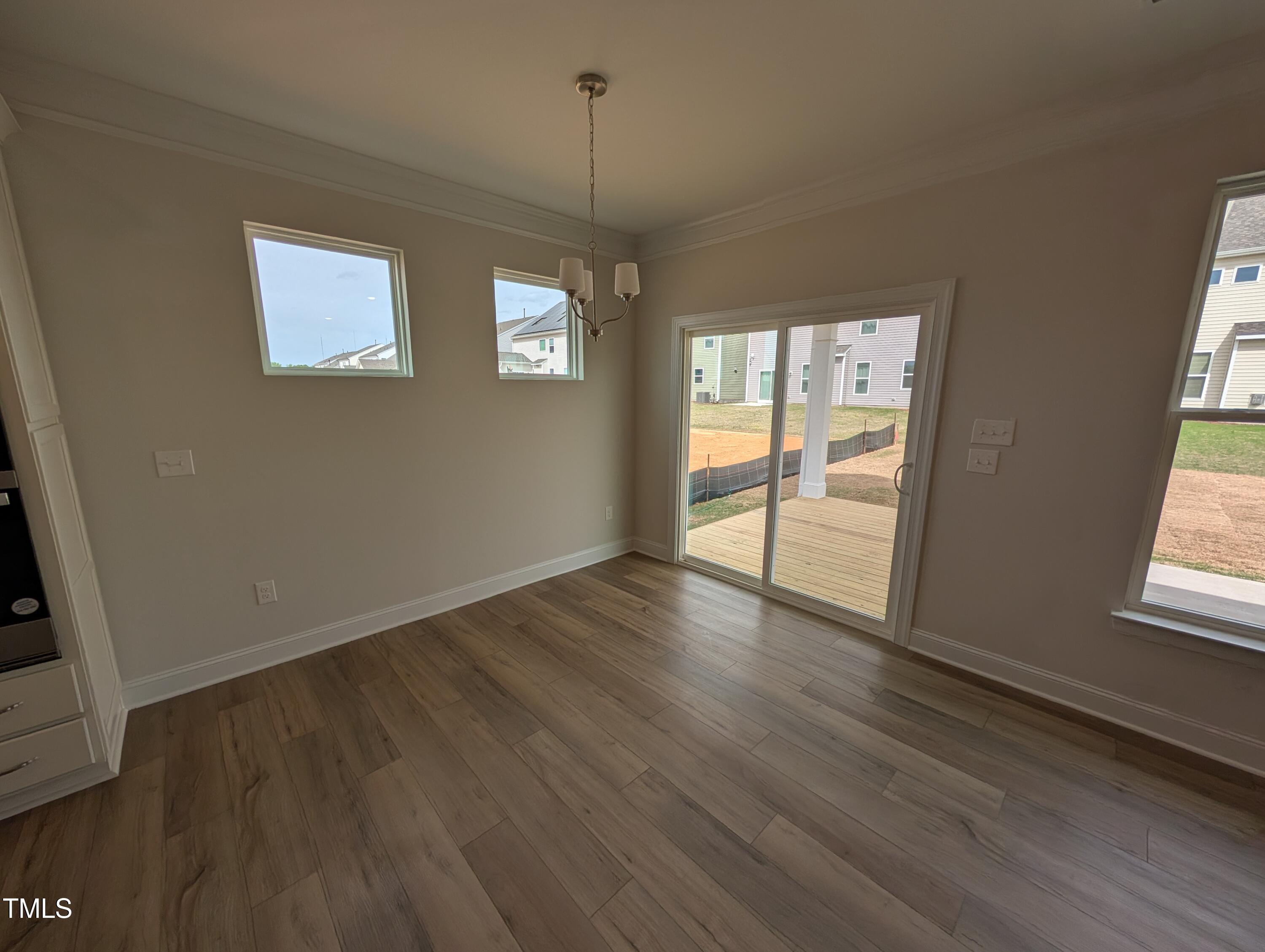 46 Steppe Way Garner, NC 27529 - Photo 11 of 31 an empty room with wooden floor and windows