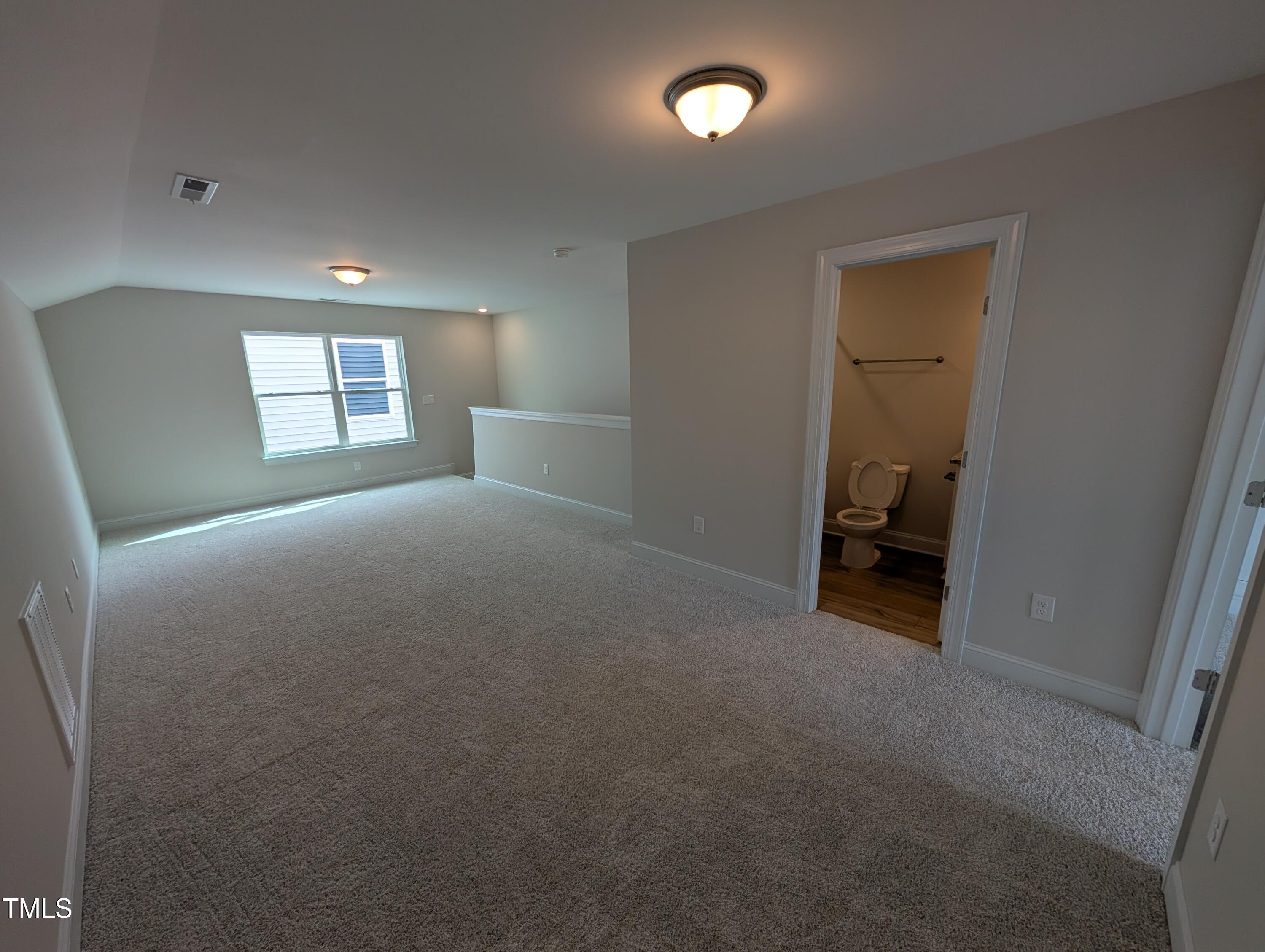 46 Steppe Way Garner, NC 27529 - Photo 20 of 31 an empty room with a chair and a window