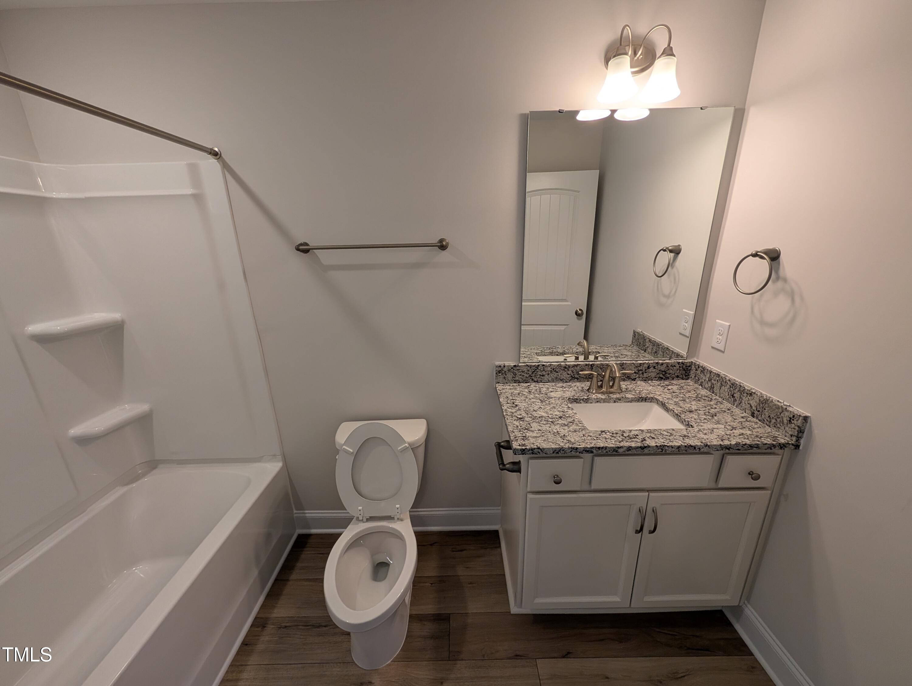 46 Steppe Way Garner, NC 27529 - Photo 21 of 31 a bathroom with a granite countertop sink a toilet and bathtub