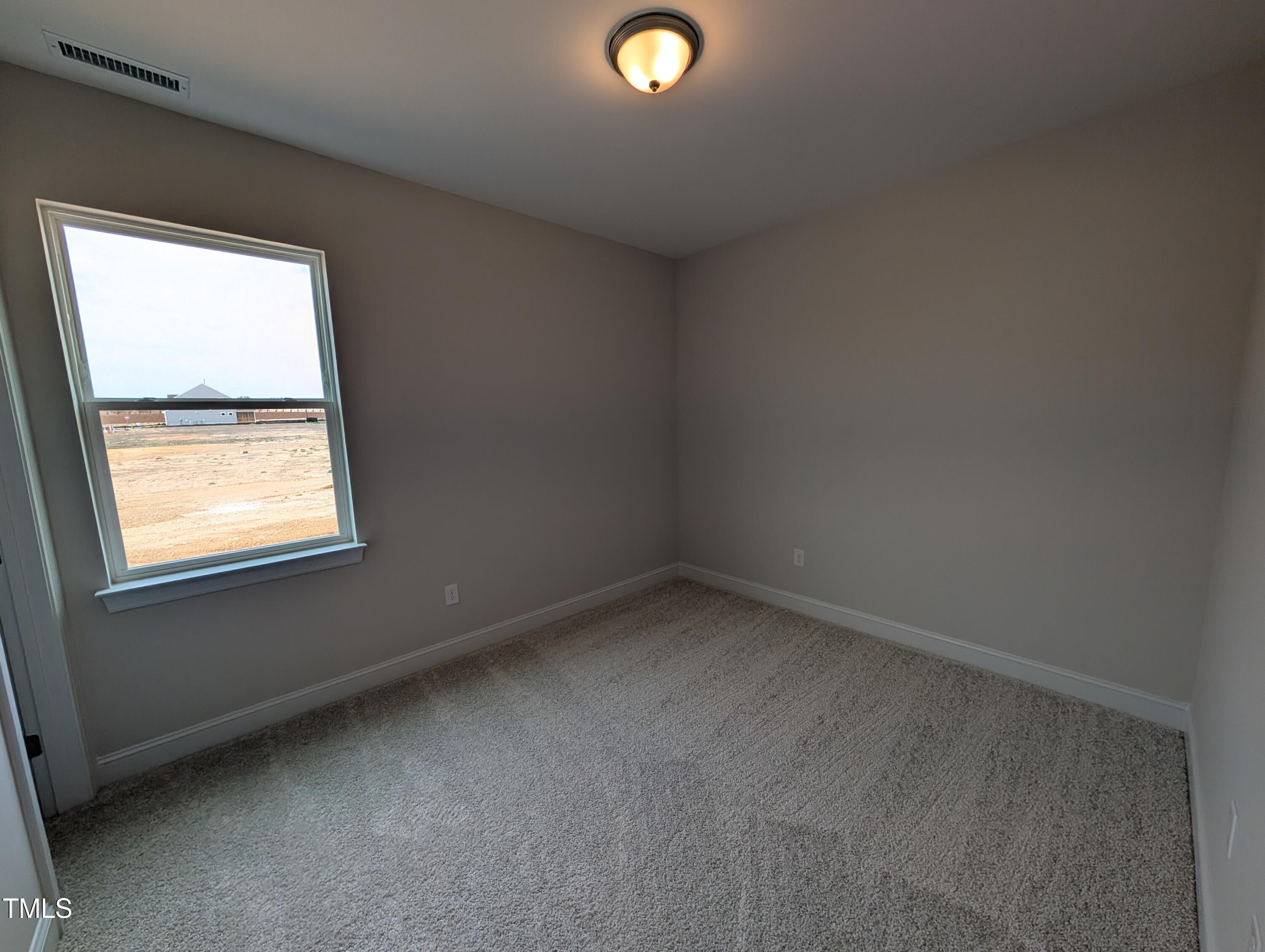 46 Steppe Way Garner, NC 27529 - Photo 4 of 31 an empty room with a window