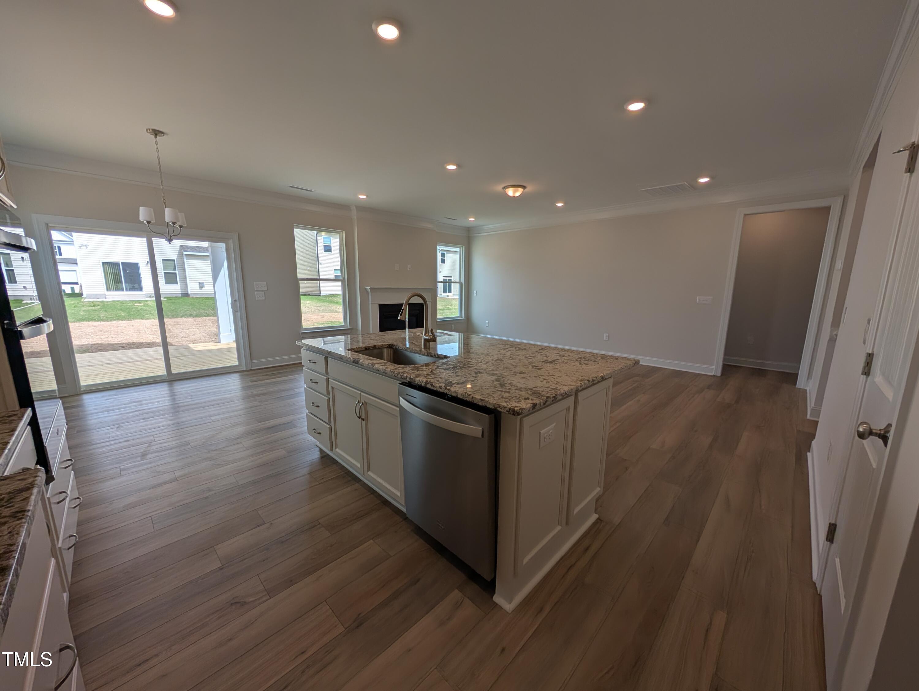 46 Steppe Way Garner, NC 27529 - Photo 10 of 31 a kitchen with stainless steel appliances granite countertop wooden floors and wide window