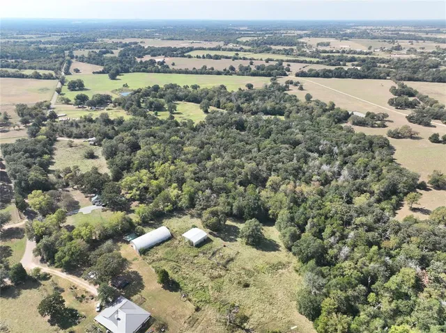 an aerial view of a houses with a lake view